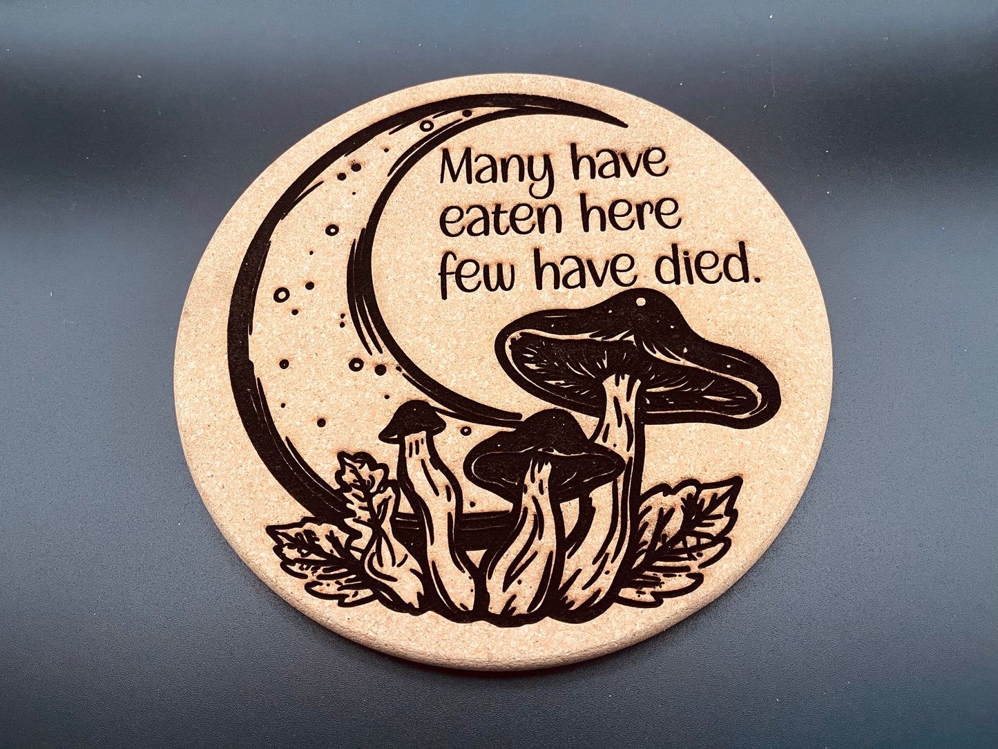 "Many Have Eaten Here, Few Have Died" Cork Trivet - 8 Inch Mushroom Moon Design