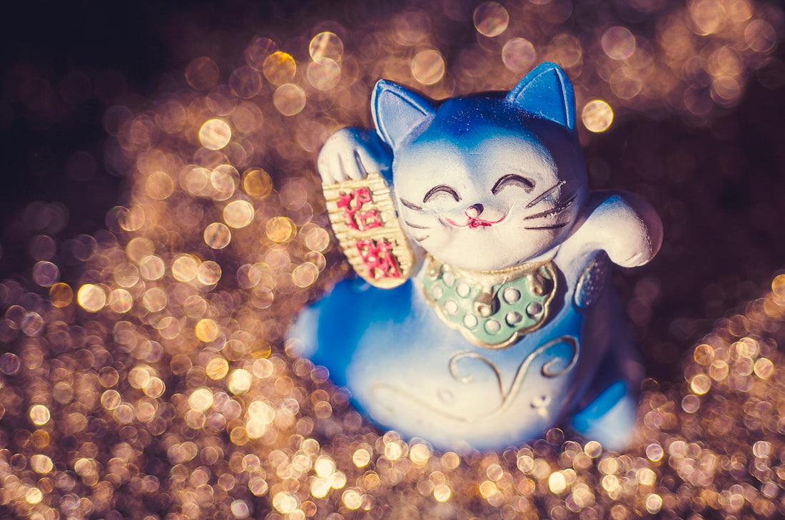 a blue cat figurine sitting on top of a table