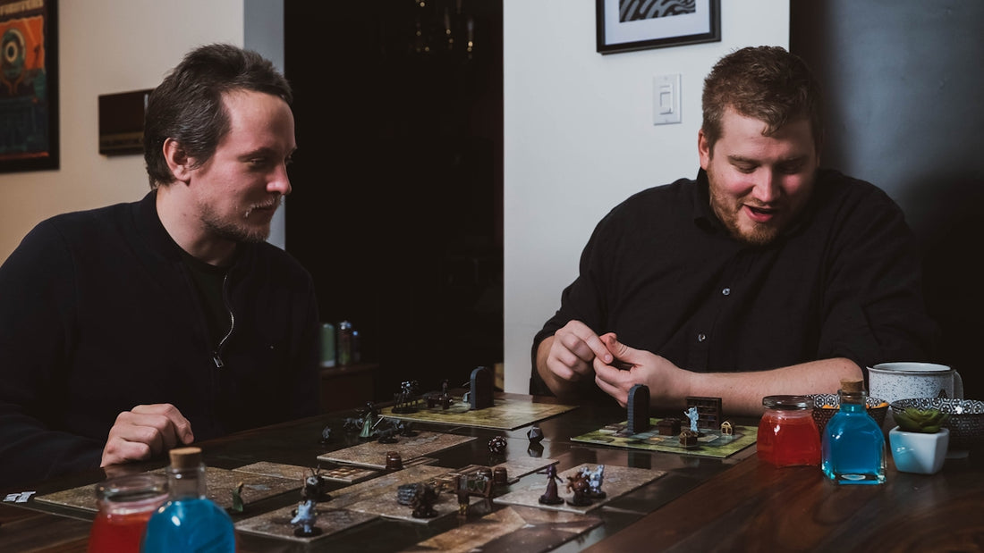two men sitting at a table playing a board game