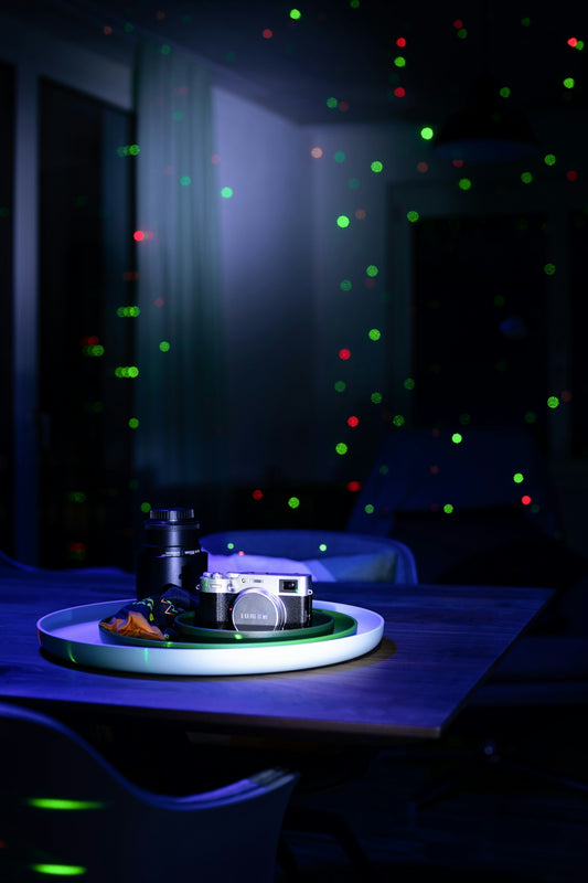 a camera sitting on top of a plate on a table