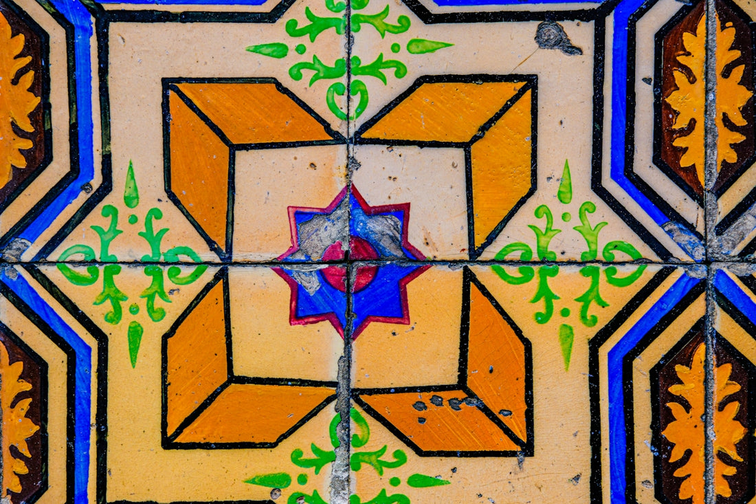 a close up of a tile with a star design on it