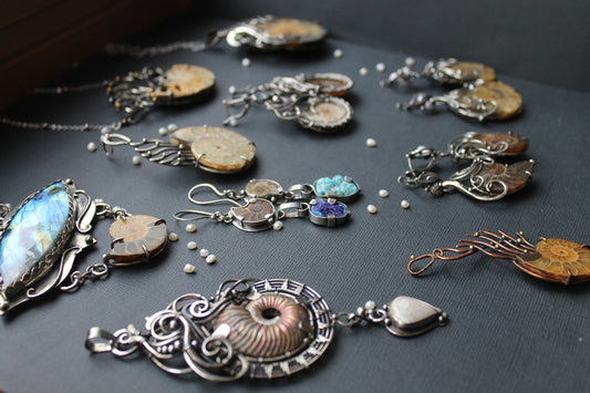 a collection of jewelry sitting on top of a table