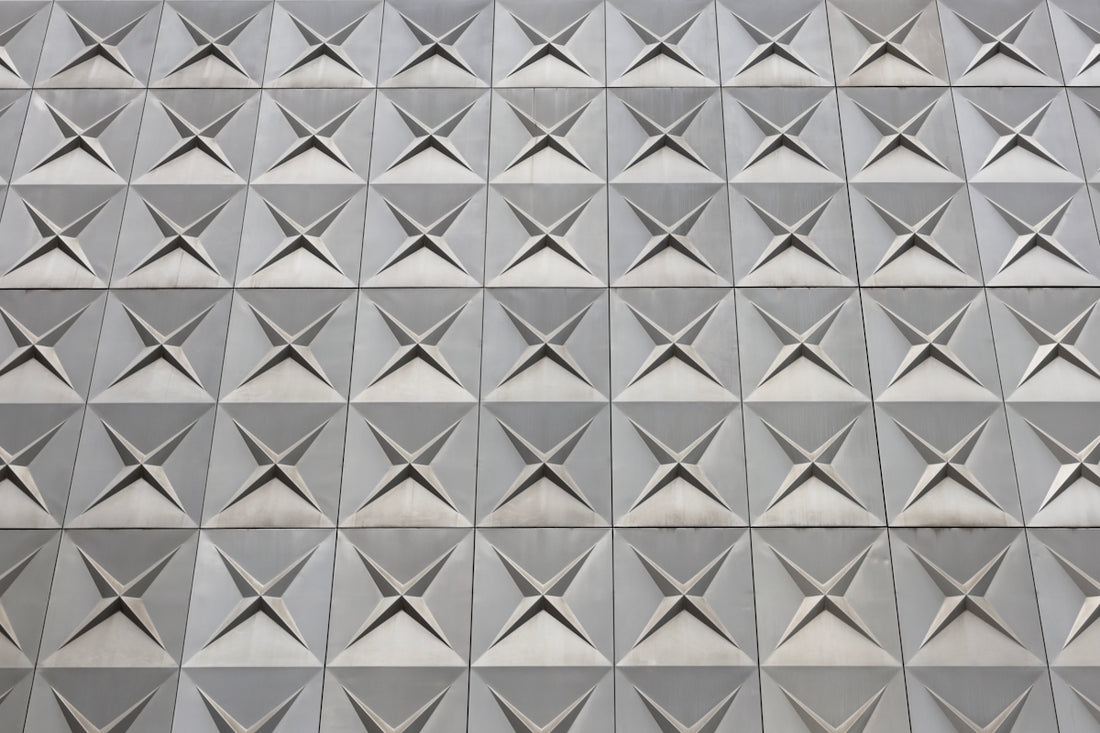 A textured wall displaying square geometric patterns.