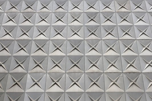 A textured wall displaying square geometric patterns.