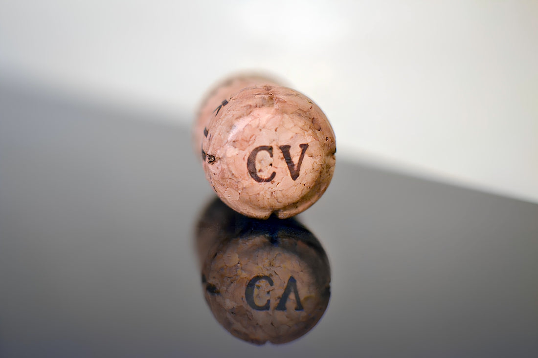 A cork with the letters cv reflects.