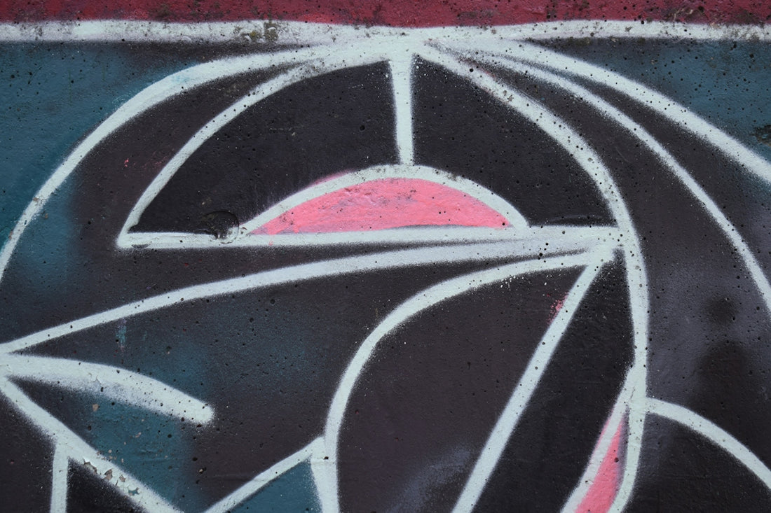 Abstract geometric design with pink and white lines.