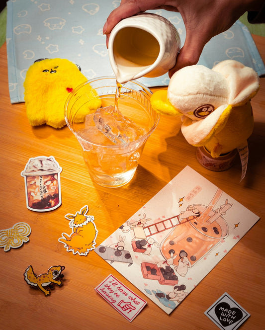 Pouring liquid into a glass with plush toys and stickers.
